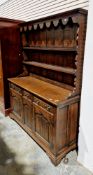 Oak dresser in the George III manner, the upper section with moulded pediment with shaped frieze