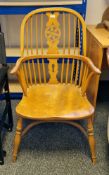 Elm and ash wheel and double combe back elbow chair, on turned legs united by a crinoline stretcher,
