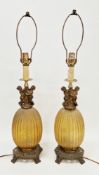 Pair of mid-century reeded crackled amber glass table lamps surmounted by gilt metal cast cherubs on