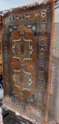 Three similar Eastern style green ground rugs with two central geometric medallions, geometric