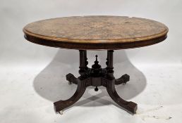 Victorian walnut inlaid centre table, the oval tilt top on a four turned tapered pillar supports
