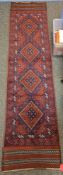 Meshwani red ground runner with four loznge medallions, geometric spandrels and multiple geometric
