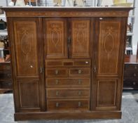 Edwardian mahogany and satinwood inlaid triple wardrobe, the centre comprising two panel doors