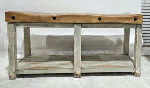 Early to mid-20th century large double length butcher's block with iron screw thread braces, on a