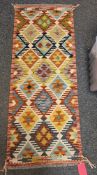 Chobi cream ground kilim runner with two rows of four and one row of five lozenge medallions,