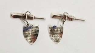 Of cricketing interest - a pair of silver-coloured cufflinks modelled as a cricket bat and a