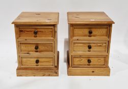 Pair of modern pine bedside chests of drawers, the square tops with thumbmould edge over three