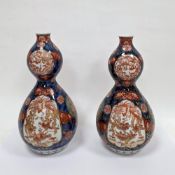 Pair of Japanese porcelain imari pattern double-gourd shaped vases, Meiji period, signed with