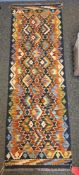 Chobi midnight blue ground kilim runner with tw0 rows of six and one row of seven loznege medallions