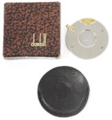 Boxed Dunhill brushed stainless steel and gilt metal pocket cigar cutter of circular form, 4.2cm