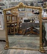 19th century gilt overmantel mirror, the domed frame with moulded decoration of ribbons and