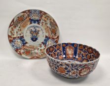 Japanese imari porcelain large fluted punchbowl, Meiji period, painted with a vase of flowers to the