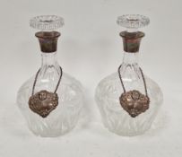 Pair of cut glass decanters and stoppers with silver collars, Birmingham 1959, Barker Brothers
