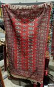 Eastern red ground rug with two rows of sixteen elephant foot guls enclosed by one and two half rows