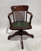 Late 19th / early 20th century stained wooden office swivel elbow chair, with slatted back and green