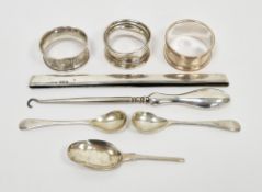 Silver napkin ring with engine-turned decoration, two further silver napkin rings, a pair of