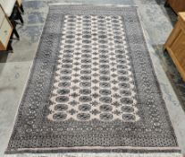 Large cream ground rug with four rows of nineteen elephant foot guls and three rows of eighteen