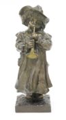 Bronze figure of a 19th century child wearing a hat and playing a trumpet, on a square plinth