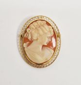 Modern gold shell cameo brooch pendant, the oval carving depicting a young lady within a wirework