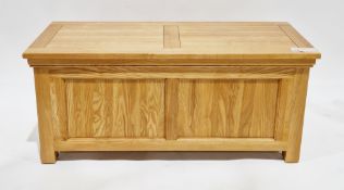 Modern pale oak blanket box, the hinged lid opening to an empty storage space, two panels to