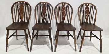 Set of four elm seated wheelback dining chairs, on turned legs united by H-stretchers, 89cm high x