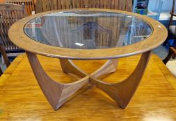 Mid-century G-Plan teak Astro coffee table of circular form with glass inset and four crossed