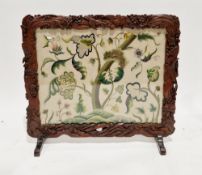 Early 20th century Asian hardwood firescreen of rectangular form, the frame carved with birds and