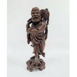 Chinese carved hardwood figure of a standing deity, 20th century, modelled holding a sceptre and a