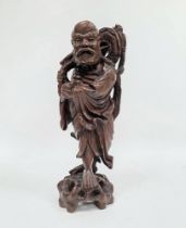 Chinese carved hardwood figure of a standing deity, 20th century, modelled holding a sceptre and a