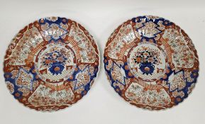Pair of Japanese imari porcelain chargers, Meiji period, of scalloped form, each painted with a vase