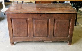 18th century oak coffer, the hinged lid with thumb moulded edge, over a three panel front, on