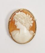 Modern 9ct gold shell cameo brooch, the oval cameo carved with a young lady within ropetwist border,