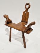 Spanish-style brutalist elm chair with shaped arms, leather studded seat, on three turned tapered