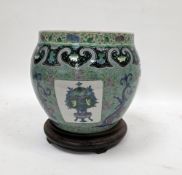 Chinese porcelain famille verte jardiniere and wooden stand, Qing Dynasty, painted with panels of