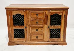Modern sheesham wood sideboard, comprising a central bank of four short drawers with metal drop ring