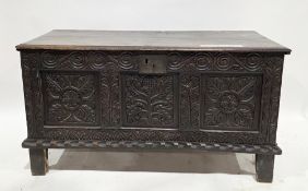 18th century oak coffer, the hinged two plank lid opening to an empty space, the three panel front