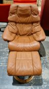 Ekornes stressless reclining armchair with brown leather upholstery, on circular laminate bases with