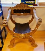 Continental walnut cross-frame elbow chair, the arms carved with mask finials with paw feet,