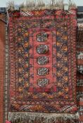 Eastern red ground rug with five central elephant foot guls, multiple geometric borders, 79cm x 52cm