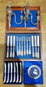 Set of six cake knives with silver pistol-grip handles in fitted case, a cased set of twelve pairs