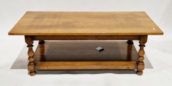 Oak coffee table, the rectangular top on turned baluster legs united by an undershelf, on bun