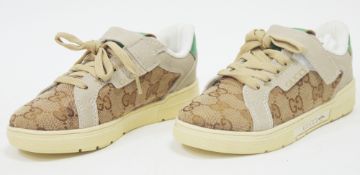 Pair of Gucci child's shoes or trainers, size 28, brown canvas printed with the GG logo, with