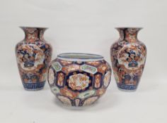 Pair of Japanese imari porcelain Meiji period oviform vases, fluted oviform, painted with