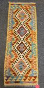 Chobi yellow ground kilim runner with one row of four lozenge medallions, single geometric border