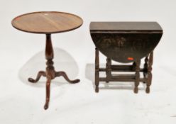 George III mahogany tilt top pedestal table, the circular dish-top on a turned baluster column