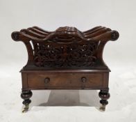 Victorian rosewood canterbury, the four division with foliate scroll pierced carving, over a