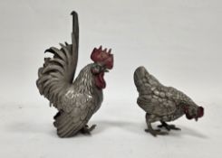 Japanese Okimono white metal alloy models of a cockerel and a hen, late Meiji/early 20th century,