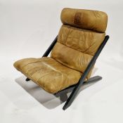 1970's Swiss low chair designed by Uli Berger for De Sede, with ebonised cross-frame and tan leather