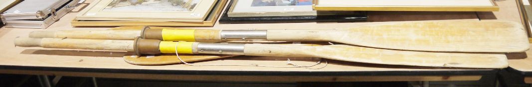 Pair of vintage Vebwagest wooden oars and another pair of vintage wooden paddles
