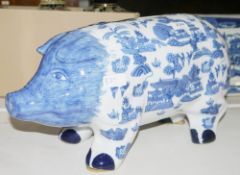 Contemporary blue and white transfer printed Willow pattern porcelain pig-shaped money bank,